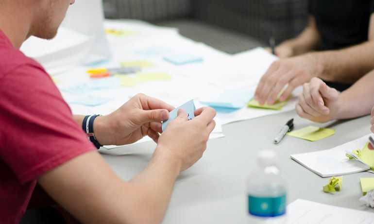 People Around The Table With Postits