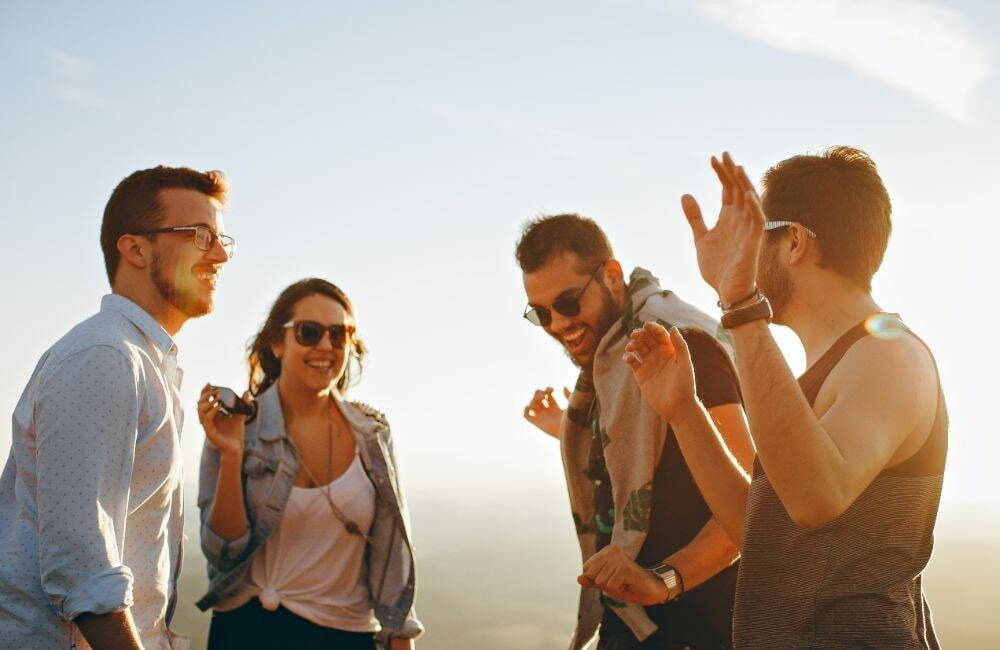 Four people outside smiling