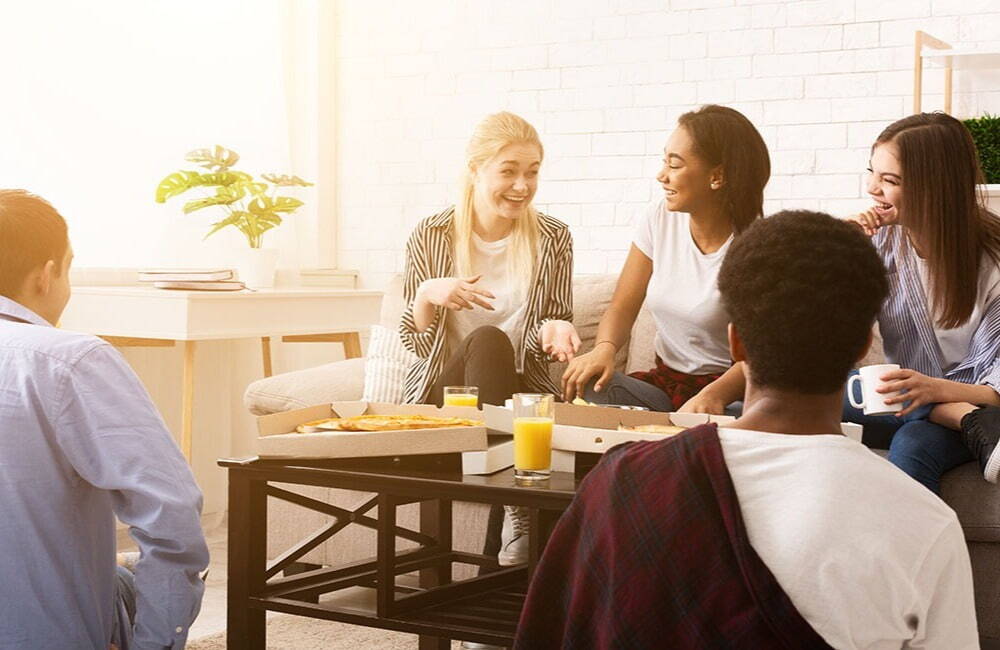 A group of colleagues eating pizza