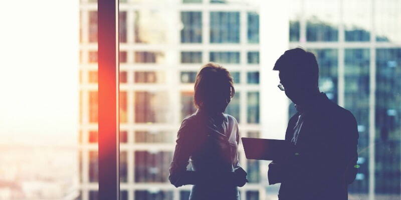 Two people talking in an office